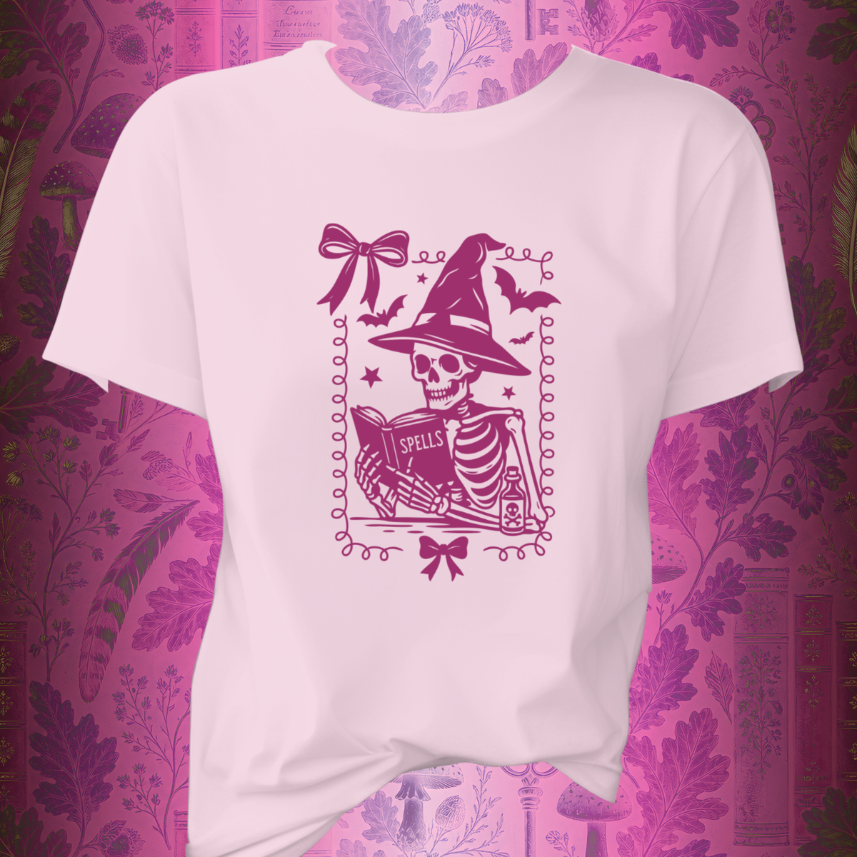 Pink Reading Witch Skeleton Tee — Cute Halloween Aesthetic Graphic T-Shirt